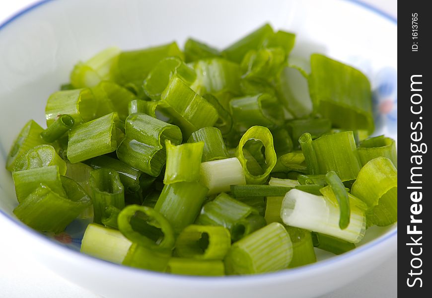 Some chopped spring onion in a small dish