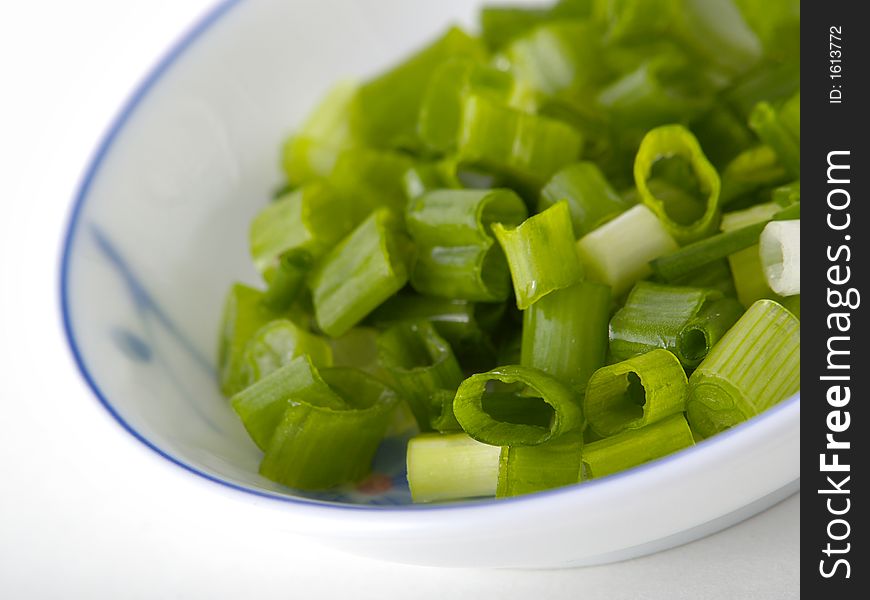 A small dish of chopped spring onion