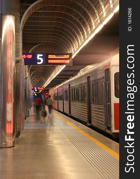 A family rushing to catch the train at a train station. A family rushing to catch the train at a train station.