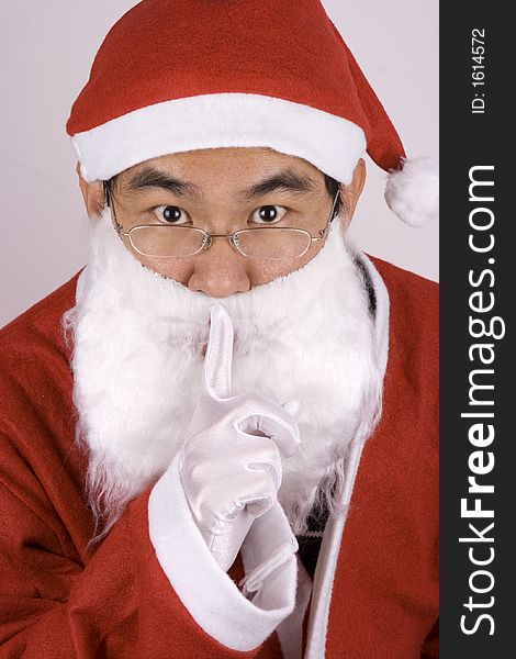Asian santa claus showing a whispering gesture. Asian santa claus showing a whispering gesture.