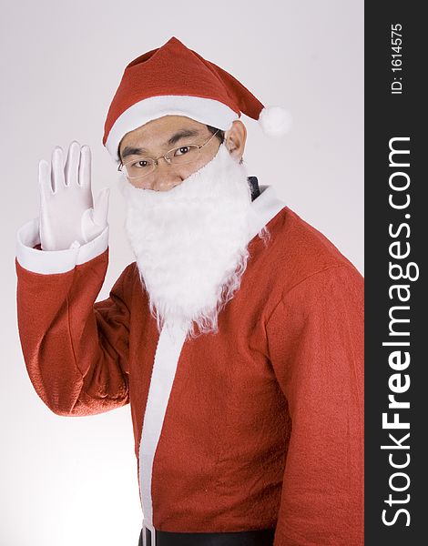 Asian Santa Claus showing greetings toward camera. Asian Santa Claus showing greetings toward camera.