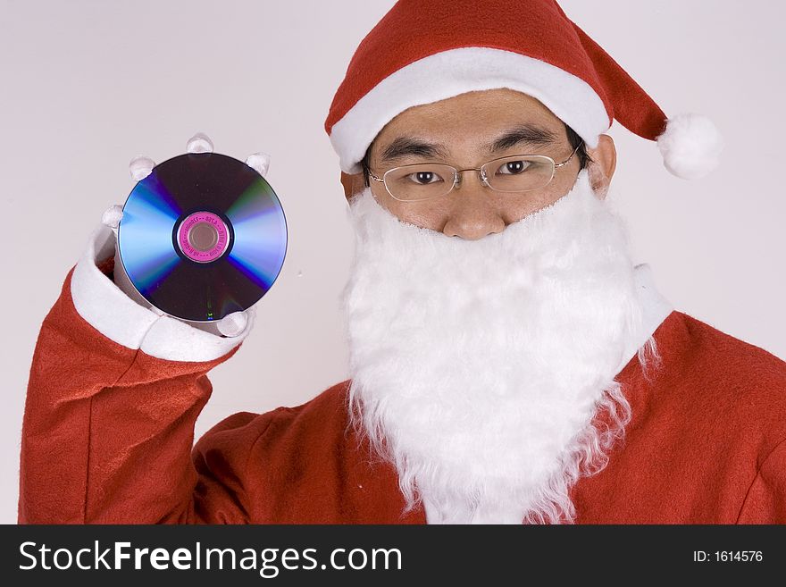 Asian Santa Claus holding a compact disc. Asian Santa Claus holding a compact disc.