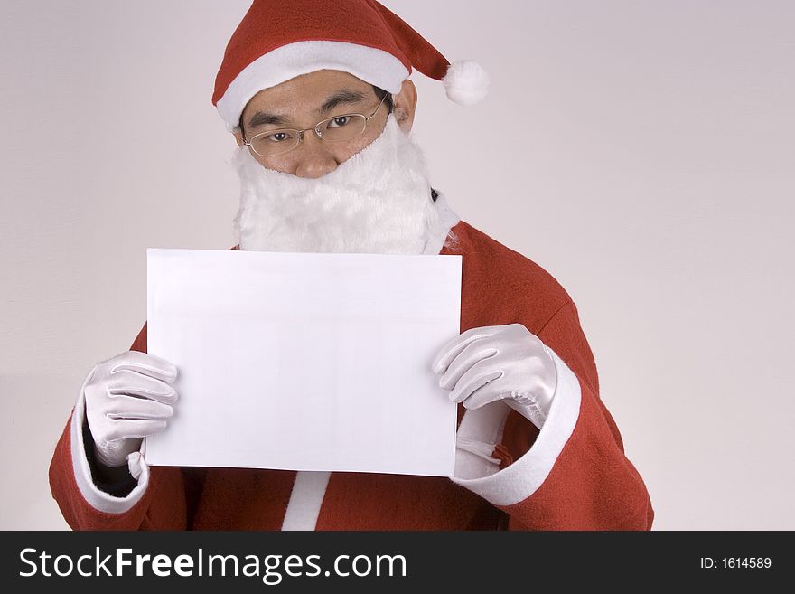 Asian santa claus holding a blank paper. Asian santa claus holding a blank paper.
