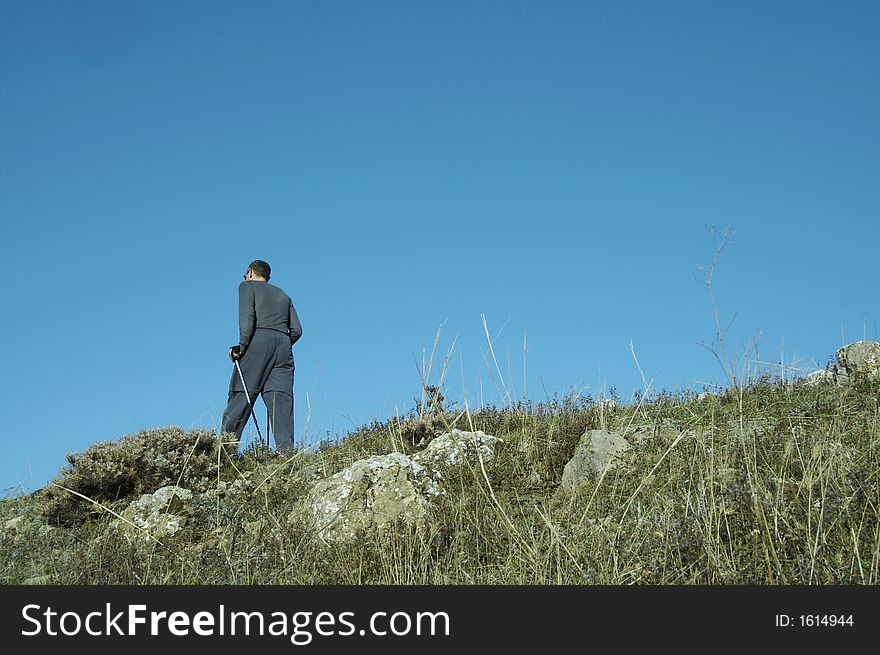 Men going up on the green hill. Men going up on the green hill