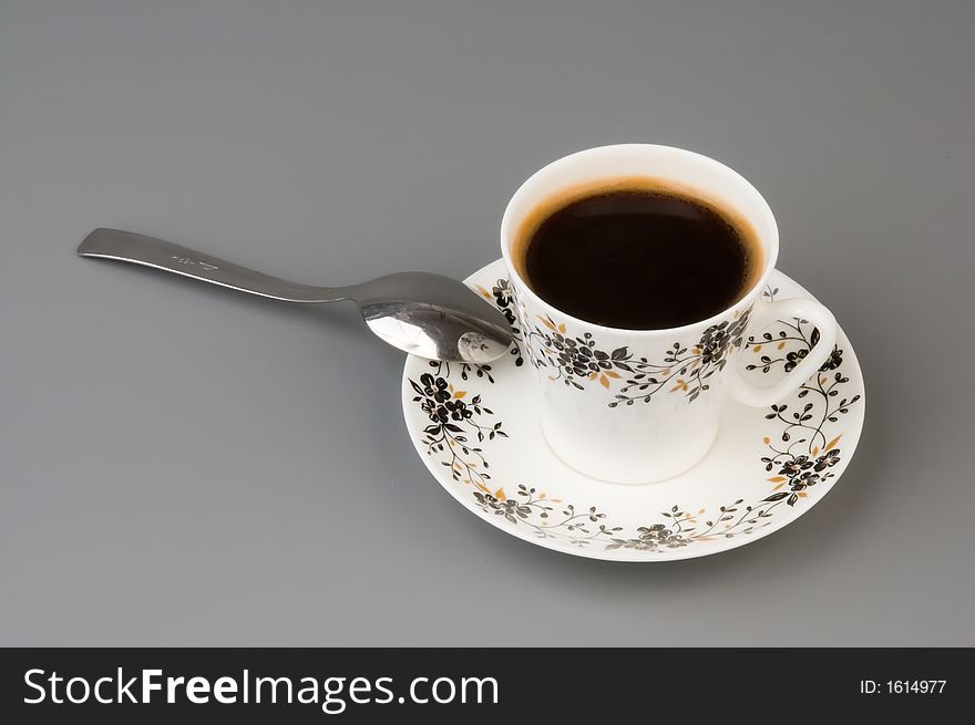 Cup of coffee over grey background