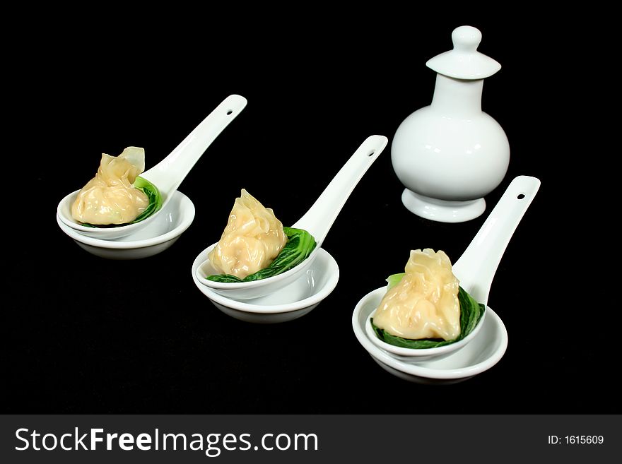 Steamed dim sums with bok choy and soy sauce. Steamed dim sums with bok choy and soy sauce.