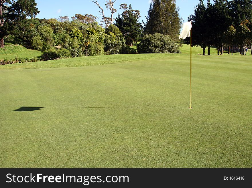 Flag and shadow on the green