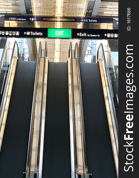 Escalators in motion inside a modern transport building