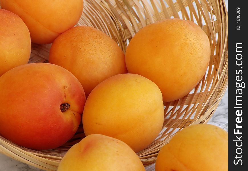 Close up of ripe apricots in basket