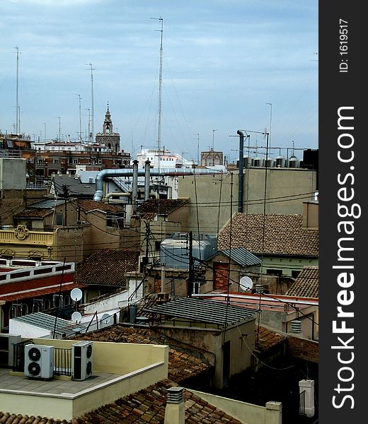 Rooftops with antennas and air-conditioner and blue-grey sky. Rooftops with antennas and air-conditioner and blue-grey sky.