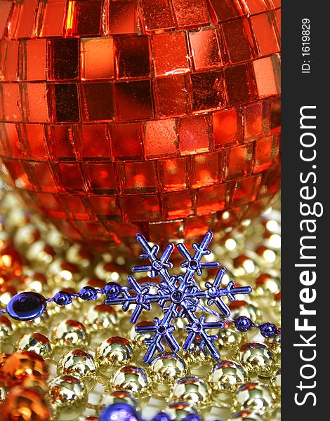 Mirror celebratory sphere of red color and snowflake of dark blue color. Mirror celebratory sphere of red color and snowflake of dark blue color