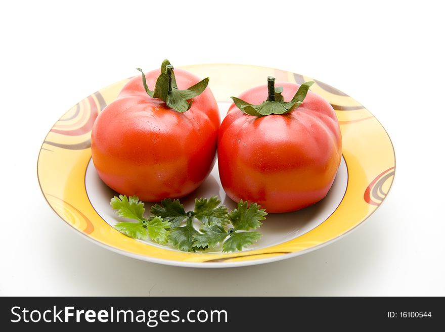 Refine tomatoes on ceramics plate. Refine tomatoes on ceramics plate
