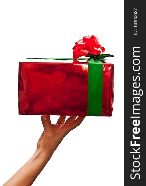 Female hand holding a christmas gift. Isolated on white. Female hand holding a christmas gift. Isolated on white