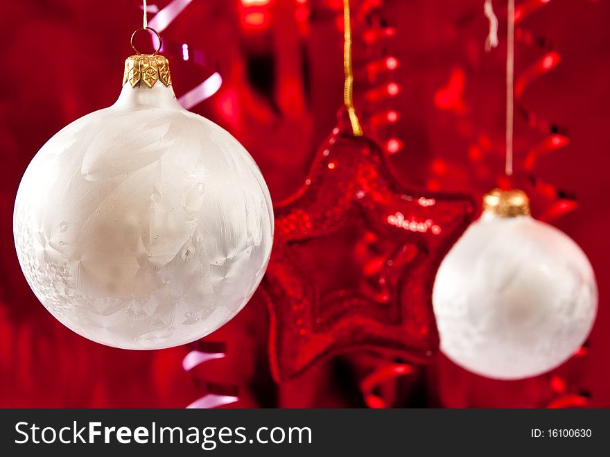 Beautiful christmas star and white baubles on red background