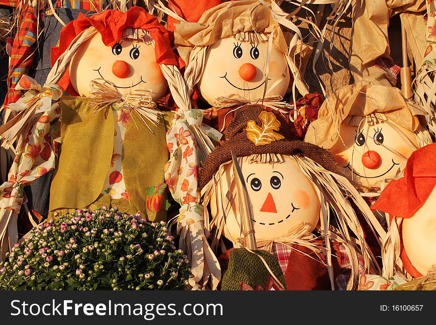 Four adorable scarecrows with fall flowers. Four adorable scarecrows with fall flowers.