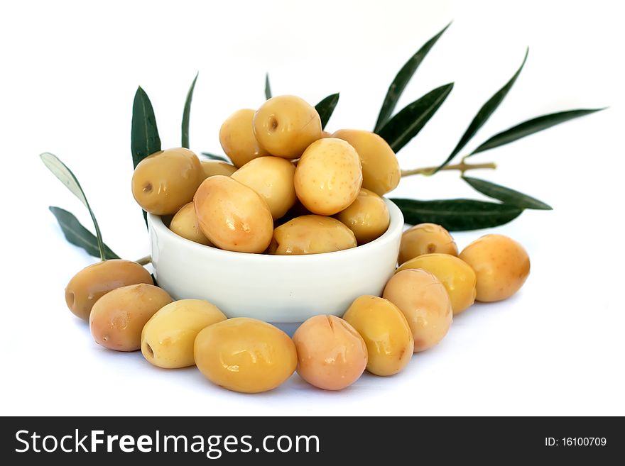 Green olives with leaves isolated on white background