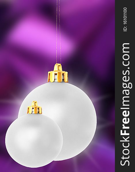 Two shiny silver christmas balls on purple background