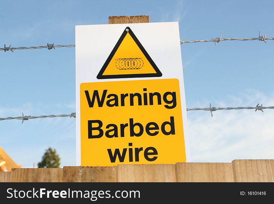 Image of a barbed wire warning sign at a construction site