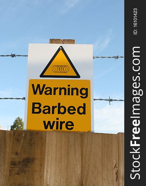 Image of a barbed wire warning sign at a construction site