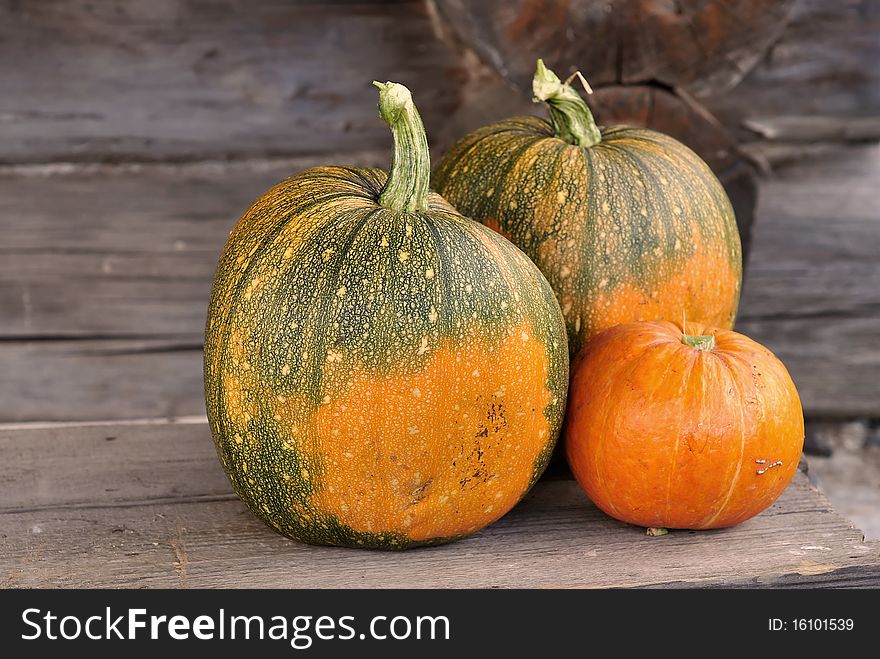 Three pumpkins against the background of old house. Three pumpkins against the background of old house.