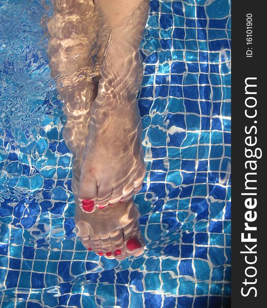 Legs in pool under water. Legs in pool under water