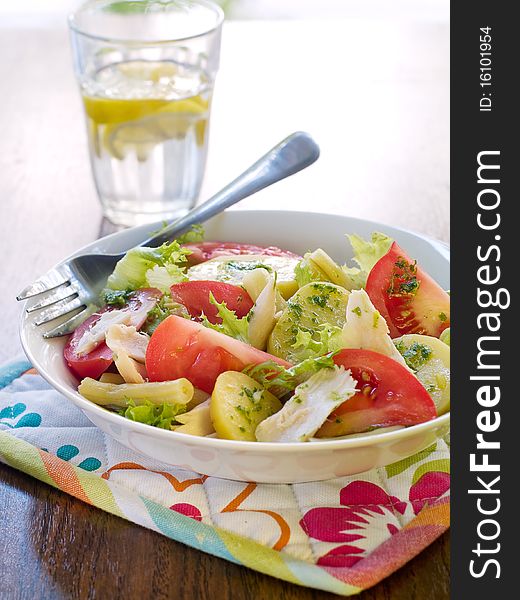 Salad from potatoes, lettuce, tomatoes and beans in bowl