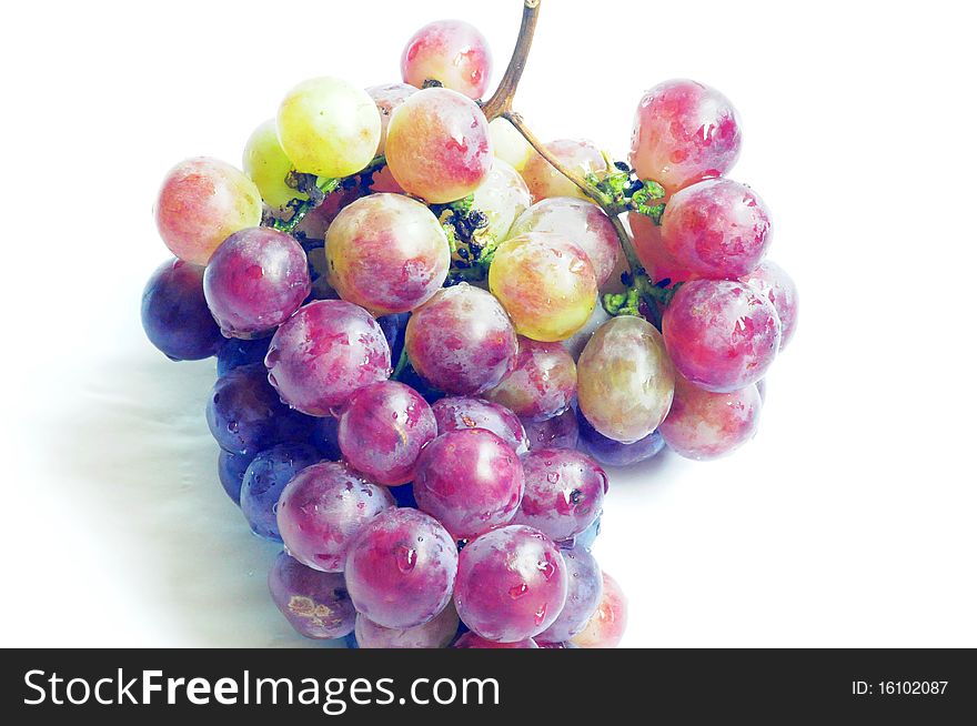 A cluster of fresh grapes isolated on a white background.