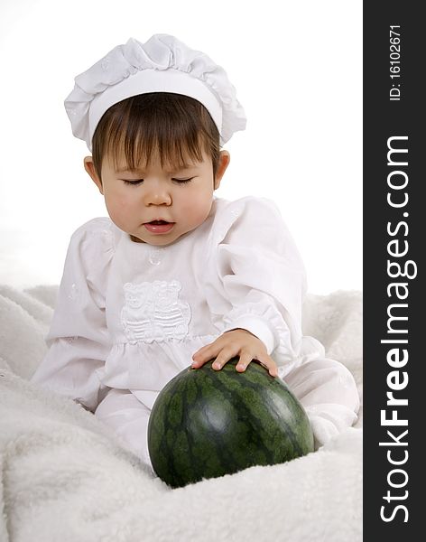 Little girl in the cook costume sitting with water melon. Little girl in the cook costume sitting with water melon