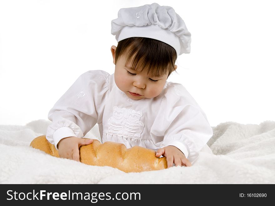 Little baby is sitting and holding bread. Little baby is sitting and holding bread