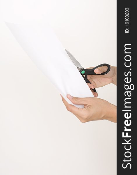 Woman cutting paper on a white background