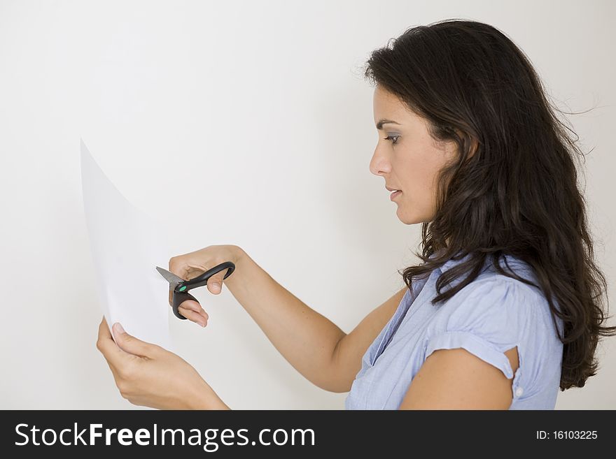 Woman cutting paper on a white background