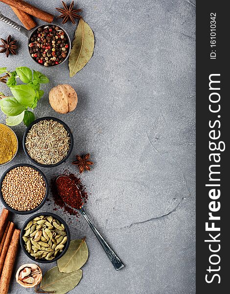 Wooden table of colorful spices. Top view. Dark background