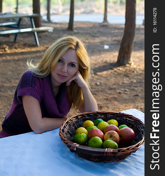 Healthy eating woman with fruits and smiling .