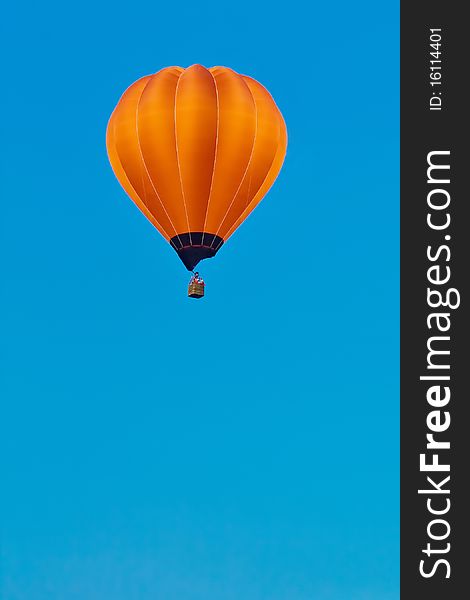 Orange balloon in blue sky