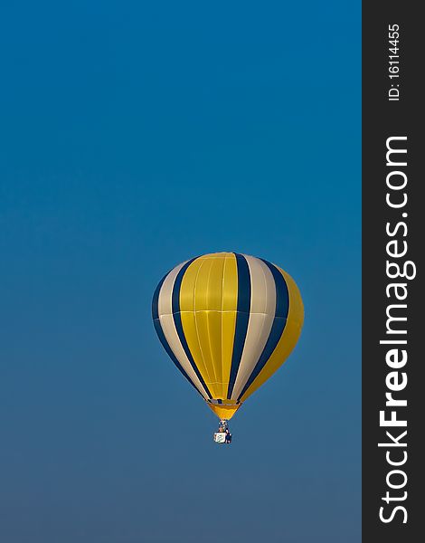 Colorful balloon in blue sky with two rider. Colorful balloon in blue sky with two rider