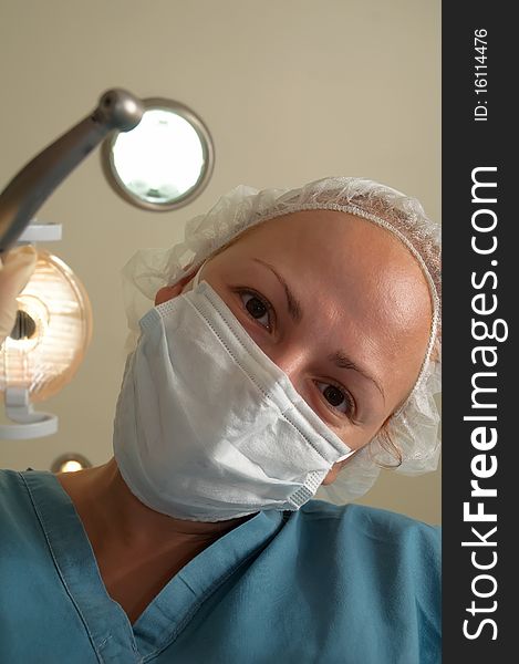 Image of female healthcare professional (doctor/nurse) wearing a surgical mask . Image of female healthcare professional (doctor/nurse) wearing a surgical mask .