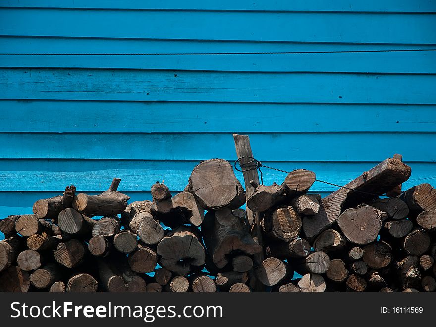 Fire wood on blue wall background