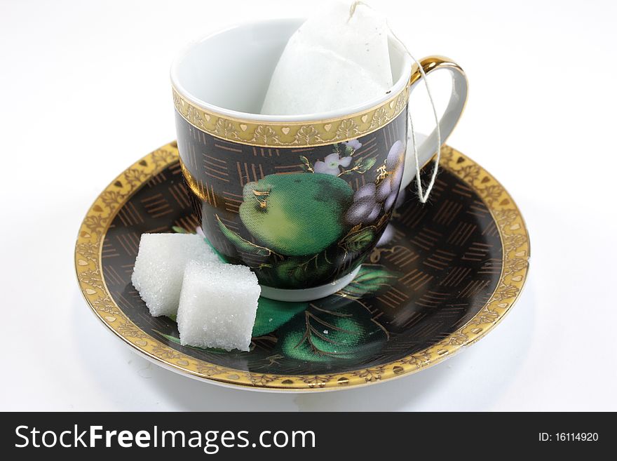 сup with tea and sugar on a white background. сup with tea and sugar on a white background