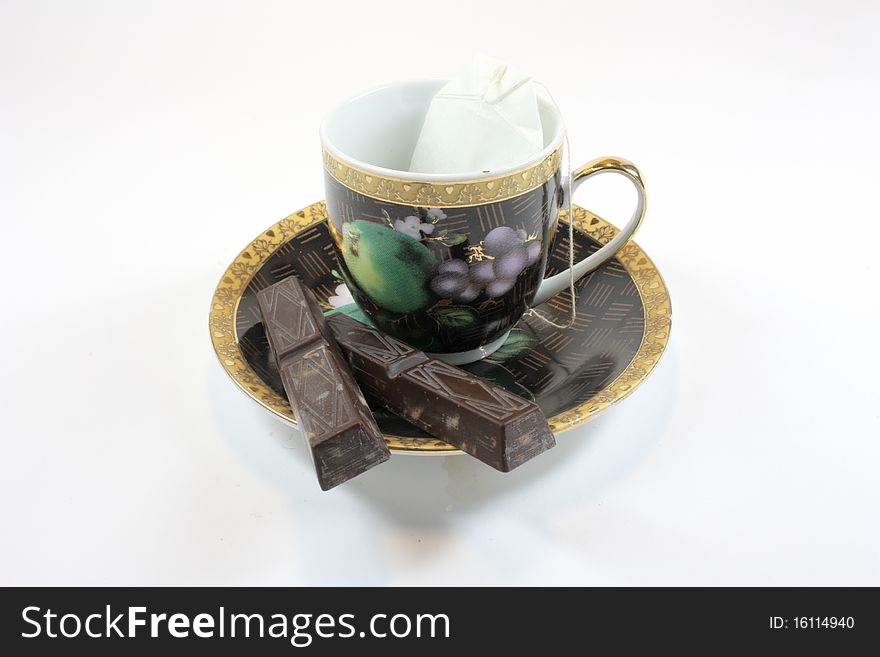 Ñup with tea chocolate and sugar on a white background. Ñup with tea chocolate and sugar on a white background