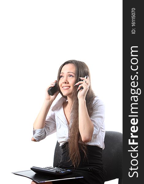 Businesswoman with a file and calculator speak by two phones. Businesswoman with a file and calculator speak by two phones