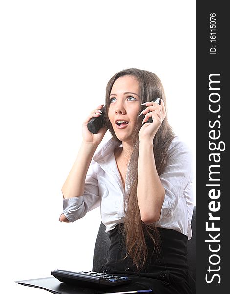 Surprised businesswoman speak by two phones