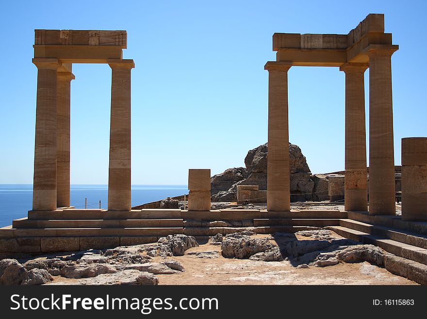 Temple of Athena at the top of the acropolis in the ancient city Lindos, Rhodes Island, Greece. Temple of Athena at the top of the acropolis in the ancient city Lindos, Rhodes Island, Greece