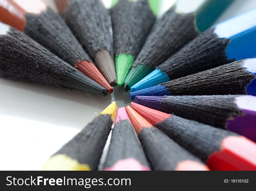 A circle of colored pencils. Made from black wood.