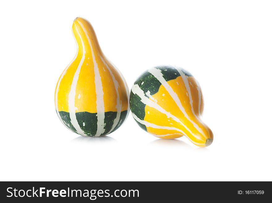 Two little green and yellow pumpkins isolated on white