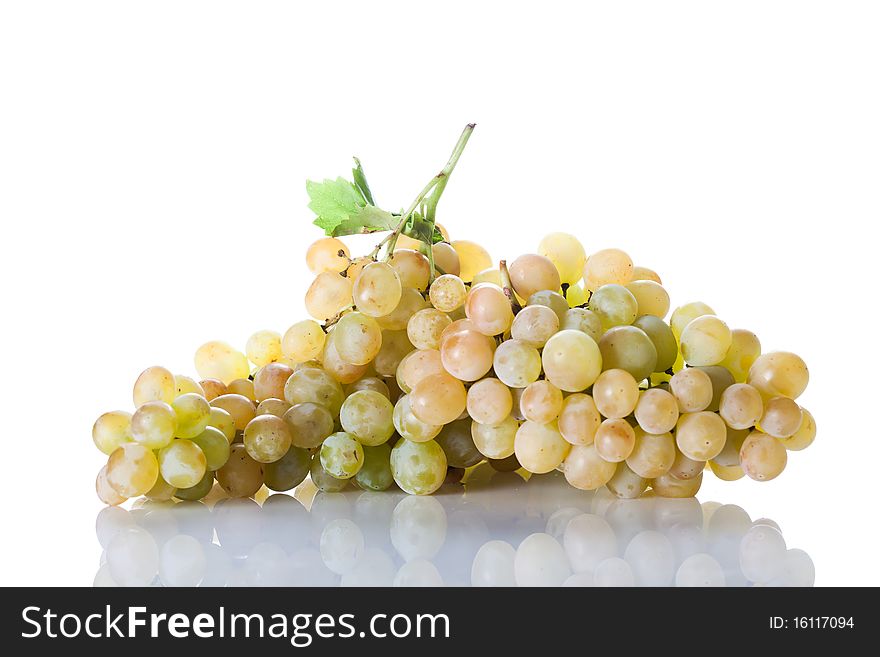 Fresh cut bunch of grapes with reflection isolated on white