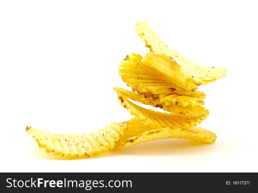 Stack of rippled potato chips isolated on white background. Stack of rippled potato chips isolated on white background