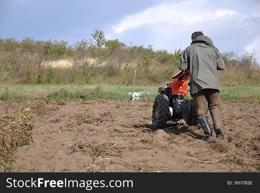 Farmer till the ground for setting potatoes. Farmer till the ground for setting potatoes