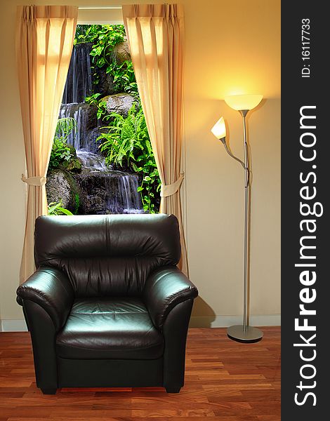 Black sofa and lamp in front of waterfall