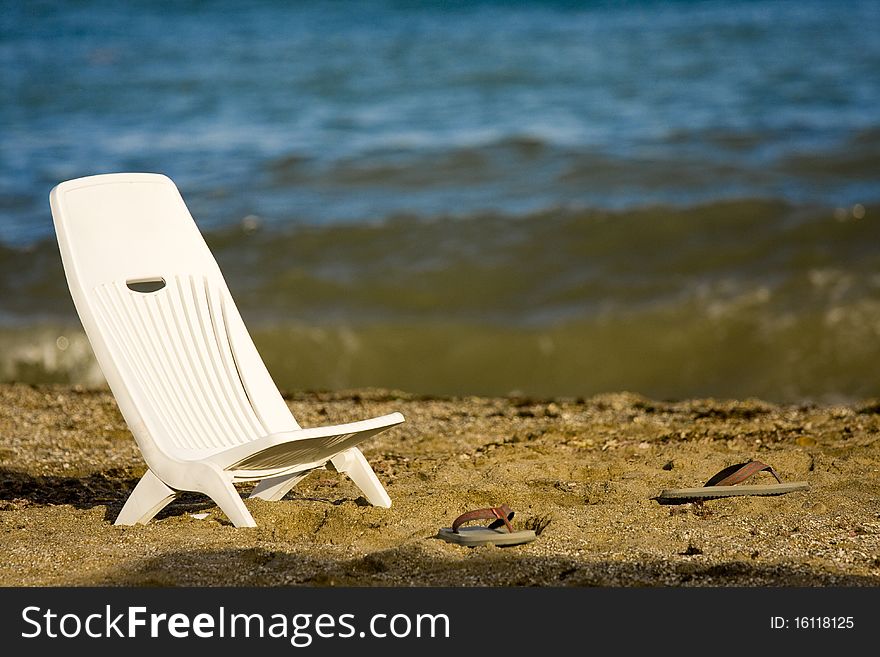 Beach sitting chair and flip flops. Beach sitting chair and flip flops