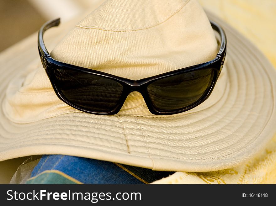 Hat and sunglasses on the beach. Hat and sunglasses on the beach